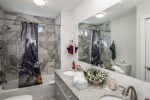 2nd Bathroom features double sinks, bath tub shower combo